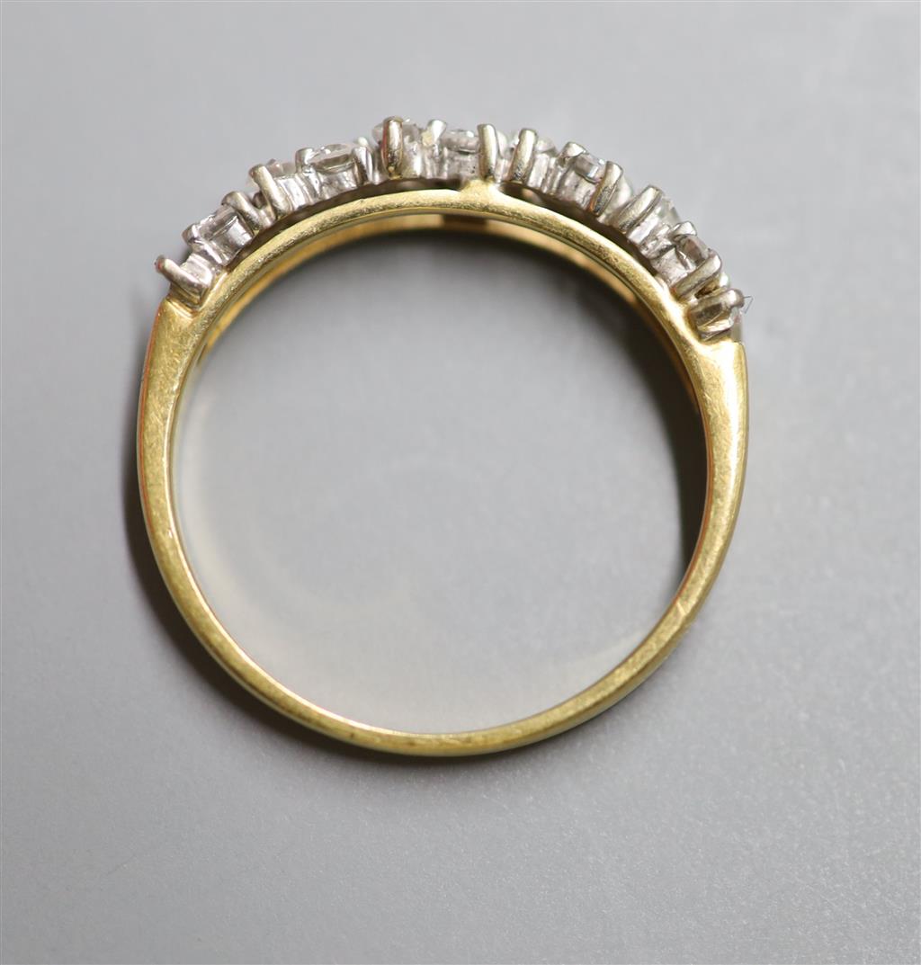 A modern 18ct gold, fives stone baguette and ten stone round cut diamond cluster set half hoop ring, size M, gross 2.8 grams,